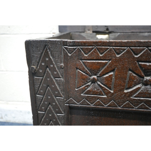 1226 - A 16TH/17TH CENTURY OAK PANELLED COFFER, with geometric pattern and repeating symbols, width 109cm x... 