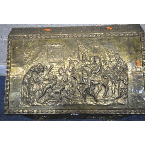 1227 - A 20TH CENTURY LOG BOX, the pressed brass depicting a variety of people, horses and buildings, with ... 