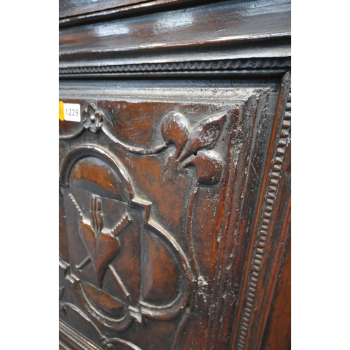 1229 - A GEORGIAN OAK HANGING CORNER CUPBOARD, with a later mahogany door panel depicting fleur de lis, qua... 