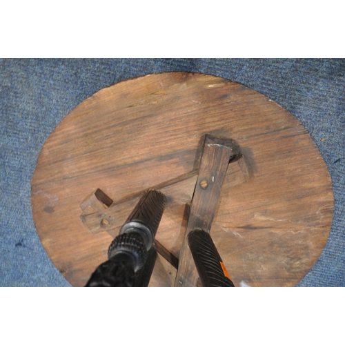 1233 - A 19TH CENTURY ORIENTAL PADAUK TWO TIER OCCASIONAL TABLE, the top circular surface carving depicting... 