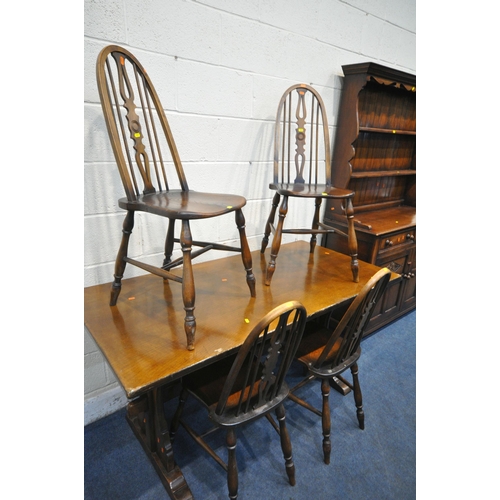 1244 - A GOOD QUALITY REPRODUCTION OAK DRESSER, the top with a two tier plate rack, the base fitted with tw... 