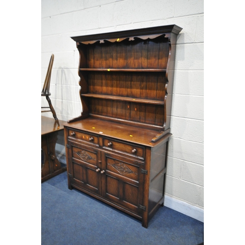 1244 - A GOOD QUALITY REPRODUCTION OAK DRESSER, the top with a two tier plate rack, the base fitted with tw... 