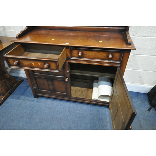 1244 - A GOOD QUALITY REPRODUCTION OAK DRESSER, the top with a two tier plate rack, the base fitted with tw... 