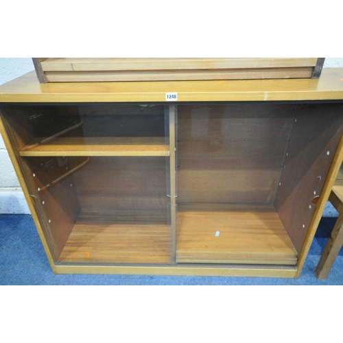 1248 - A MID CENTURY TEAK BOOKCASE, with double glazed sliding doors, enclosing four adjustable shelves, wi... 