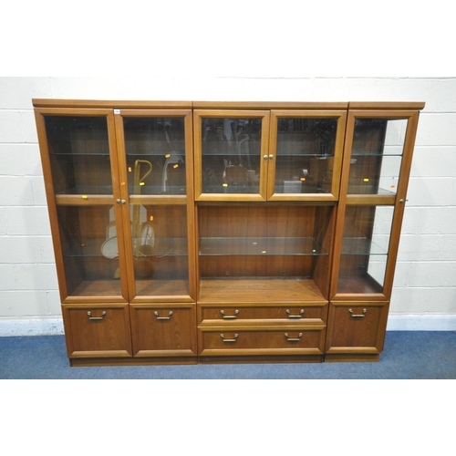 1250 - A MID CENTURY G PLAN TEAK WALL CABINET, comprising three sections, one section with double glazed do... 