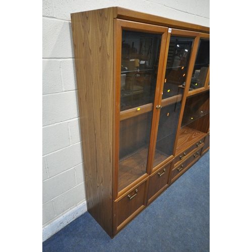 1250 - A MID CENTURY G PLAN TEAK WALL CABINET, comprising three sections, one section with double glazed do... 