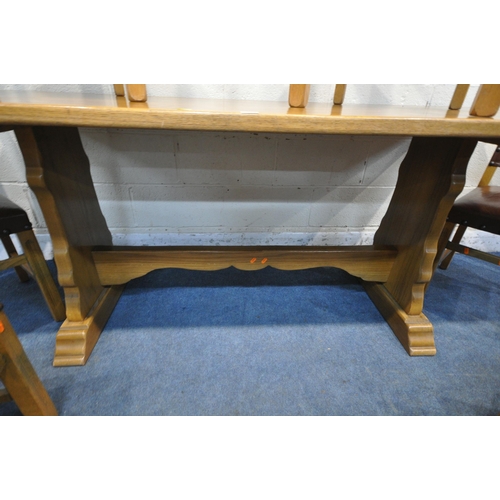 1257 - A 20TH CENTURY OAK RECTANGULAR DINING TABLE, with twin trestle legs, united by a stretcher, length 1... 