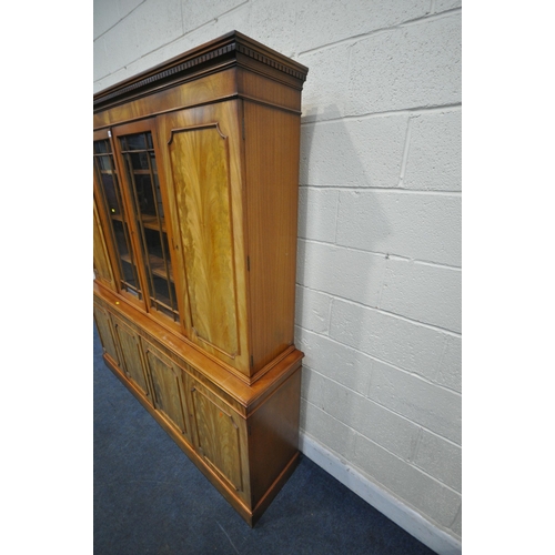 1259 - A 20TH CENTURY WALNUT BOOKCASE, the top section with two cupboard doors, flanking double glazed door... 