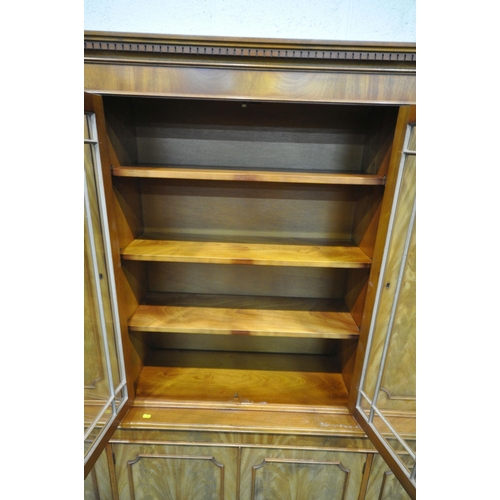 1259 - A 20TH CENTURY WALNUT BOOKCASE, the top section with two cupboard doors, flanking double glazed door... 