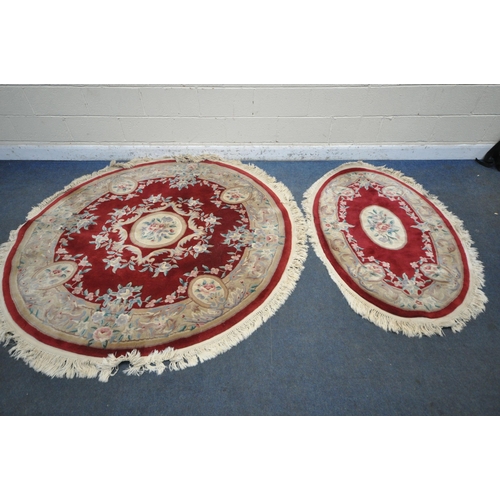 1262 - A RED AND CREAM CIRCULAR CHINESE WOOLLEN RUG, with central medallion and foliate details, diameter 1... 