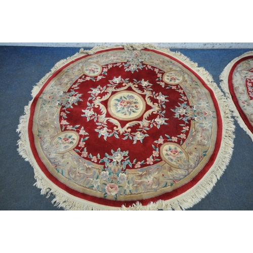 1262 - A RED AND CREAM CIRCULAR CHINESE WOOLLEN RUG, with central medallion and foliate details, diameter 1... 