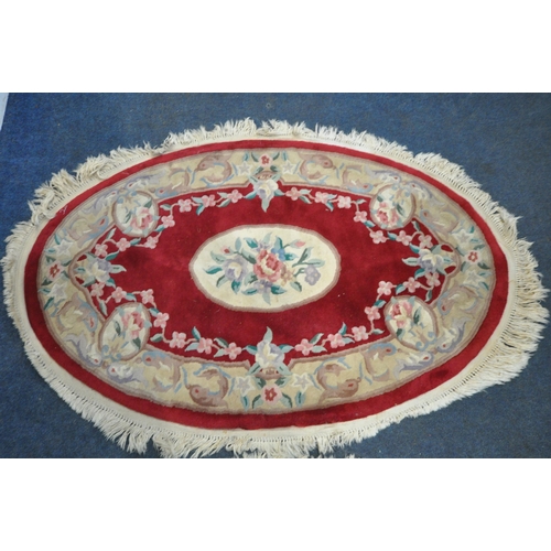 1262 - A RED AND CREAM CIRCULAR CHINESE WOOLLEN RUG, with central medallion and foliate details, diameter 1... 