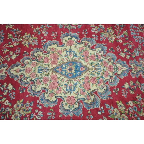 1264 - A 20TH CENTURY PERSIAN TABRIZ RUG, the red field with a central cream and floral medallion, surround... 