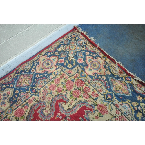 1264 - A 20TH CENTURY PERSIAN TABRIZ RUG, the red field with a central cream and floral medallion, surround... 