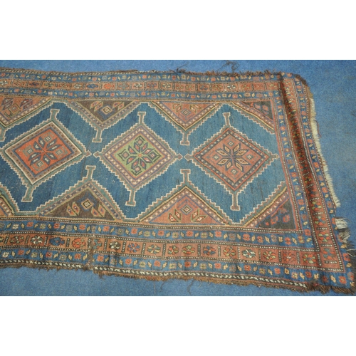 1265 - A HAND WOVEN WOOL CARPET RUNNER, with a six medallions, within a blue field and multi strap border, ... 