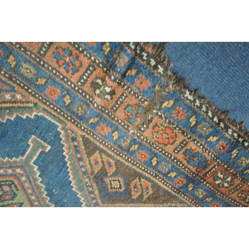 1265 - A HAND WOVEN WOOL CARPET RUNNER, with a six medallions, within a blue field and multi strap border, ... 