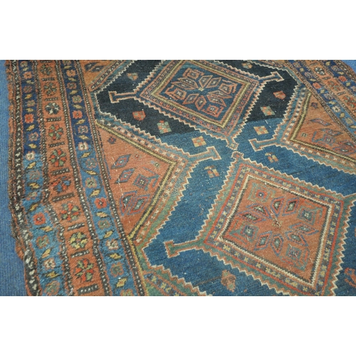 1265 - A HAND WOVEN WOOL CARPET RUNNER, with a six medallions, within a blue field and multi strap border, ... 