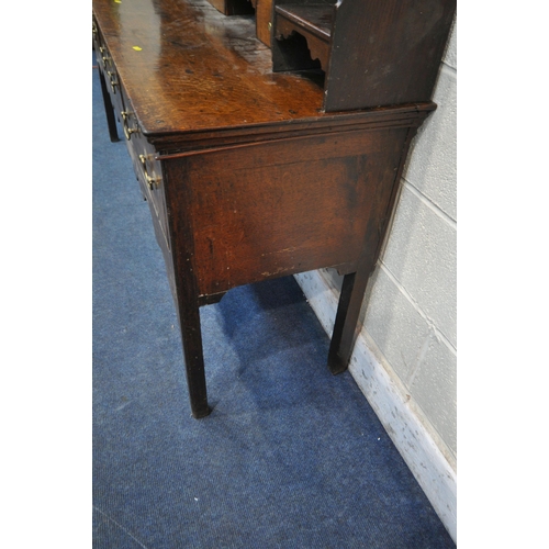 1269 - A GEORGIAN OAK DRESSER BASE, fitted with an arrangement of six drawers and two storage sections, wit... 