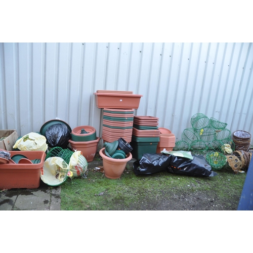 1011 - A LARGE COLLECTION OF PLASTIC PLANTERS AND HANGING BASKETS including wire globes, baskets, and half ... 