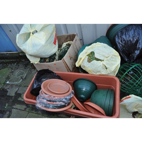 1011 - A LARGE COLLECTION OF PLASTIC PLANTERS AND HANGING BASKETS including wire globes, baskets, and half ... 