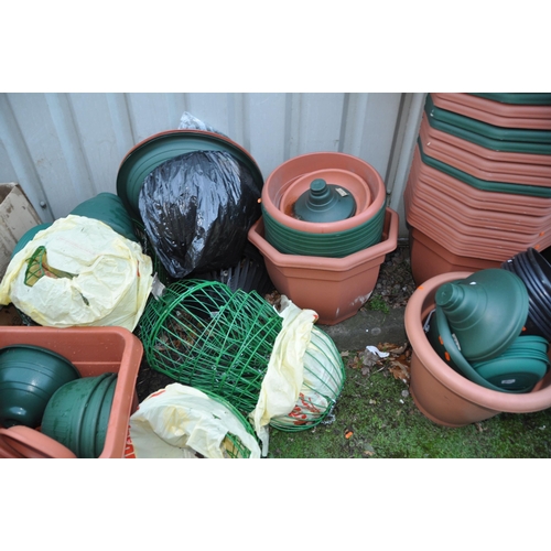 1011 - A LARGE COLLECTION OF PLASTIC PLANTERS AND HANGING BASKETS including wire globes, baskets, and half ... 