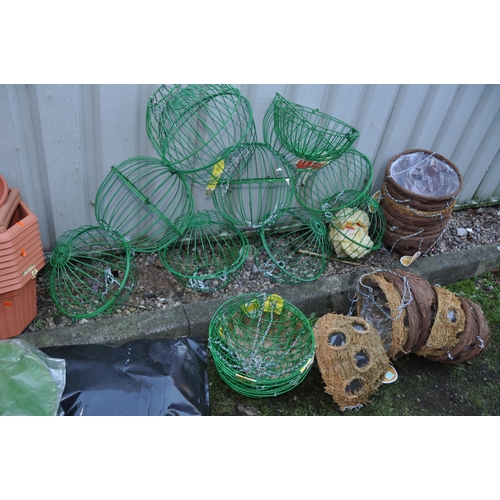 1011 - A LARGE COLLECTION OF PLASTIC PLANTERS AND HANGING BASKETS including wire globes, baskets, and half ... 