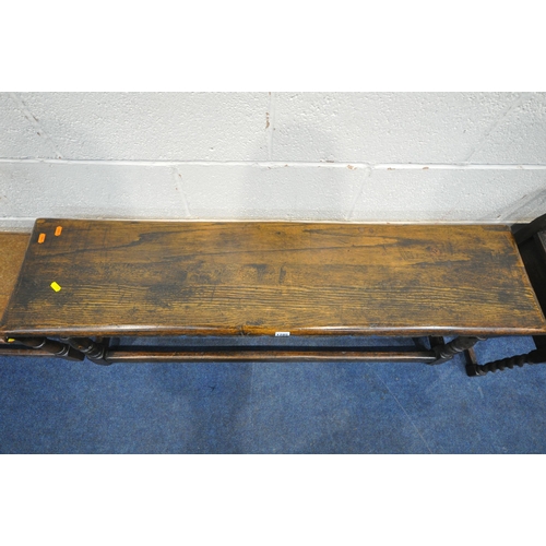 1285 - AN EARLY 2OTH CENTURY OAK BENCH, with wavy apron, turned and block legs, united by stretchers, lengt... 