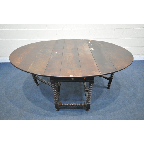 1286 - A GEORGIAN OAK OVAL BOBBIN TURNED GATE LEG TABLE, with a single drawer to each end, open width 182cm... 