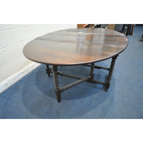 1286 - A GEORGIAN OAK OVAL BOBBIN TURNED GATE LEG TABLE, with a single drawer to each end, open width 182cm... 