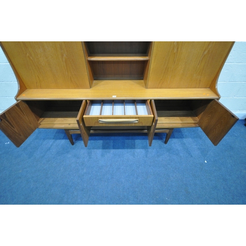 1294 - A MID CENTURY TEAK G PLAN HIGHBOARD, fitted with a sliding door and fall front door, above four door... 