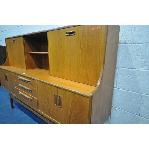 1294 - A MID CENTURY TEAK G PLAN HIGHBOARD, fitted with a sliding door and fall front door, above four door... 