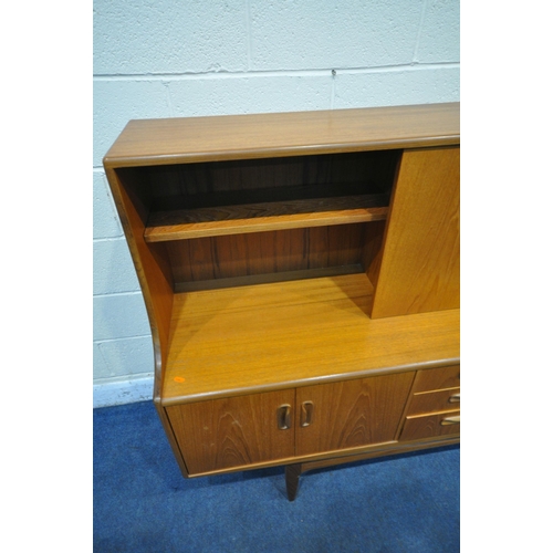 1294 - A MID CENTURY TEAK G PLAN HIGHBOARD, fitted with a sliding door and fall front door, above four door... 