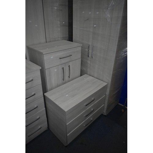 1304 - A MODERN TEN PIECE GREY FINISH BEDROOM SUITE, comprising a four double door wardrobes, one with a si... 