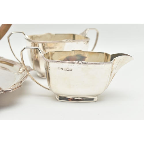 102 - A GEORGE VI THREE PIECE TEA SET, comprised of a tea pot a sugar bowl and milk jug, art deco style ra... 