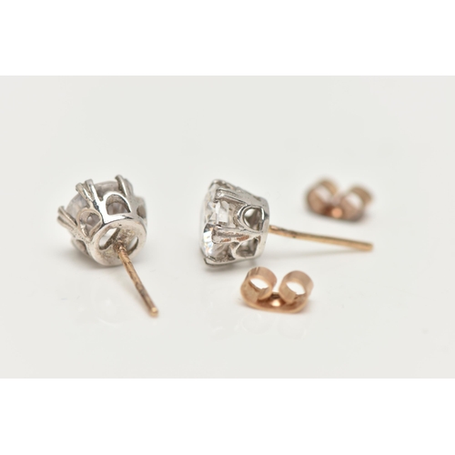 11 - A PAIR OF 9CT GOLD STUD EARRINGS, round cut cubic zirconia, prong set in white gold, fitted with yel... 