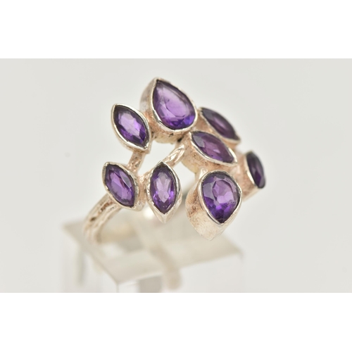 13 - AN AMETHYST RING, designed as pear and marquise cut amethysts in collet settings to the branch style... 