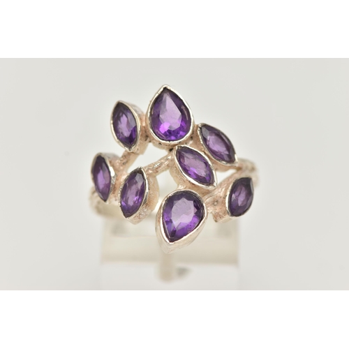 13 - AN AMETHYST RING, designed as pear and marquise cut amethysts in collet settings to the branch style... 