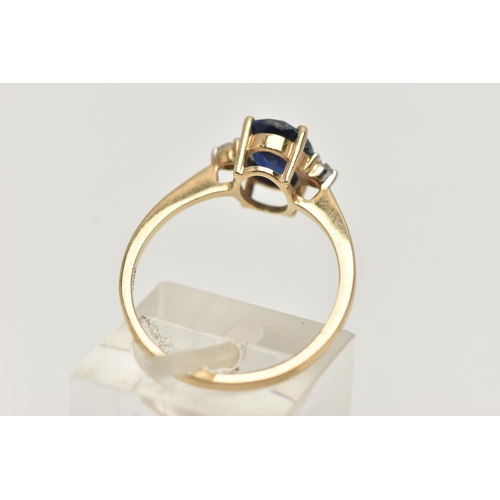 15 - A 9CT GOLD SAPPHIRE AND DIAMOND RING, designed as a central oval sapphire flanked by rose cut diamon... 