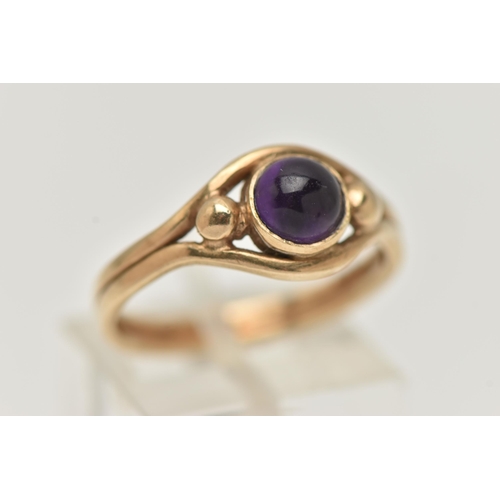 17 - A 9CT GOLD AMETHYST RING, designed as a central amethyst cabochon in a collet setting to the outer c... 