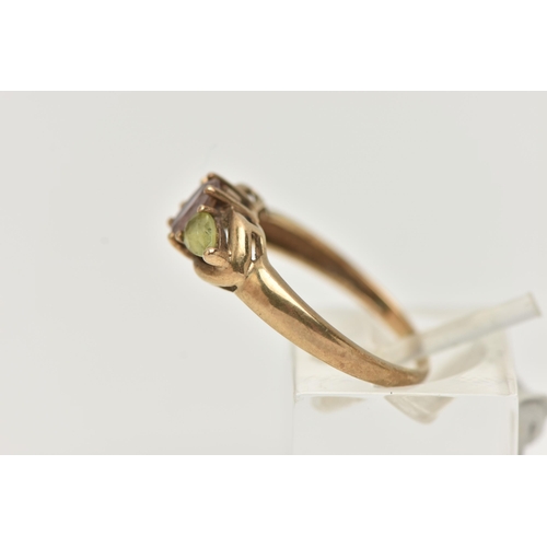 26 - A 9CT GOLD GEM SET RING, an oval cut amethyst accompanied with two pear cut peridots, prong set in y... 
