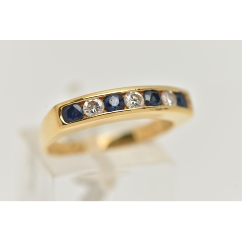 39 - AN 18CT GOLD DIAMOND AND SAPPHIRE BAND RING, three round brilliant cut diamonds and four round cut s... 