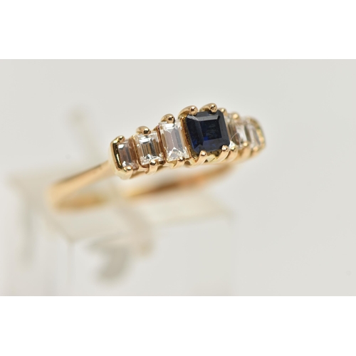 40 - A DIAMOND AND SAPPHIRE DRESS RING, a principally set cushion cut sapphire, flanked with six baguette... 