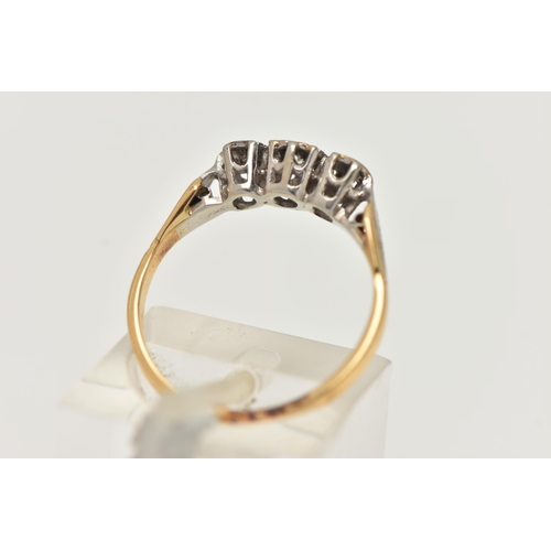 42 - A THREE STONE DIAMOND RING, an old cut diamond with two rose cut diamonds, set in a white metal illu... 
