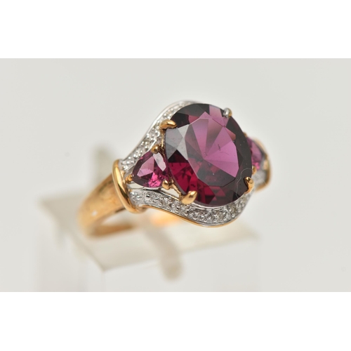 59 - A 9CT GOLD GARNET AND DIAMOND DRESS RING, centring on an oval cut garnet, four claw set, flanked by ... 
