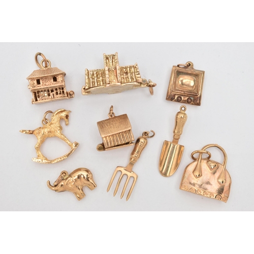 64 - NINE CHARMS, to include seven 9ct gold charms in forms such as a handbag, shovel, television, rockin... 