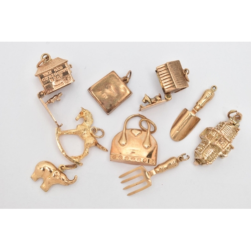 64 - NINE CHARMS, to include seven 9ct gold charms in forms such as a handbag, shovel, television, rockin... 