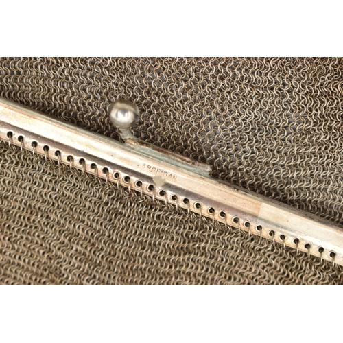 74 - A WHITE METAL MESH PURSE, fitted with an elongated oval chain strap (condition report: general moder... 