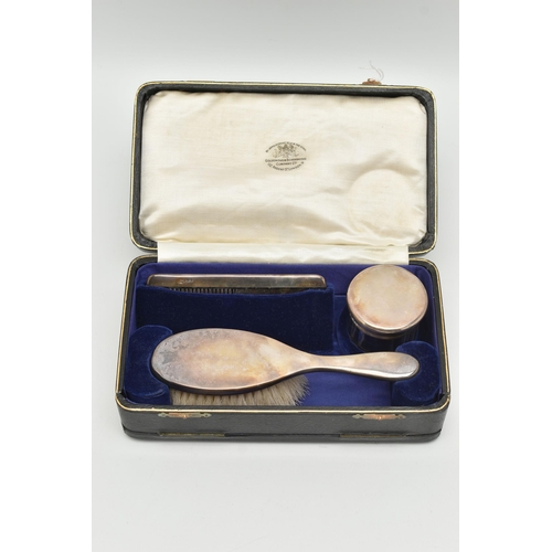 80 - A CASED EARLY 20TH CENTURY TRAVEL SET, comprising of a polished silver hair brush, a silver lined co... 