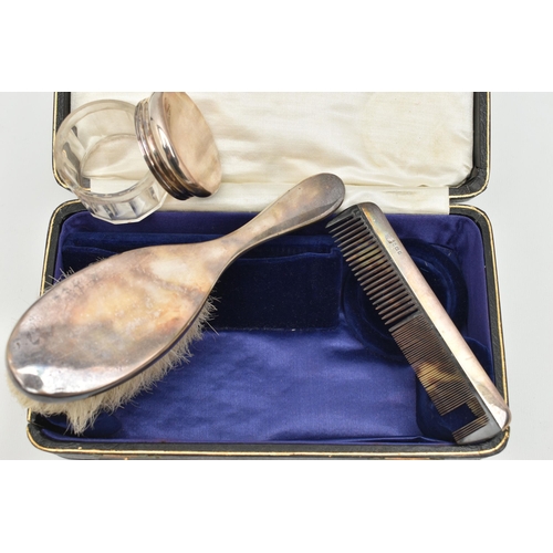 80 - A CASED EARLY 20TH CENTURY TRAVEL SET, comprising of a polished silver hair brush, a silver lined co... 