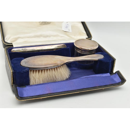 80 - A CASED EARLY 20TH CENTURY TRAVEL SET, comprising of a polished silver hair brush, a silver lined co... 